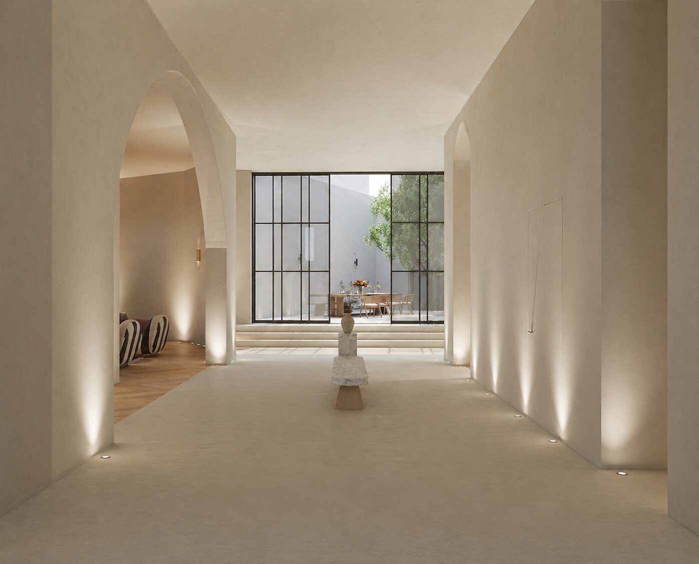 Casa Reina — limewashed entrance hall with an arched opening and wall-wash lighting